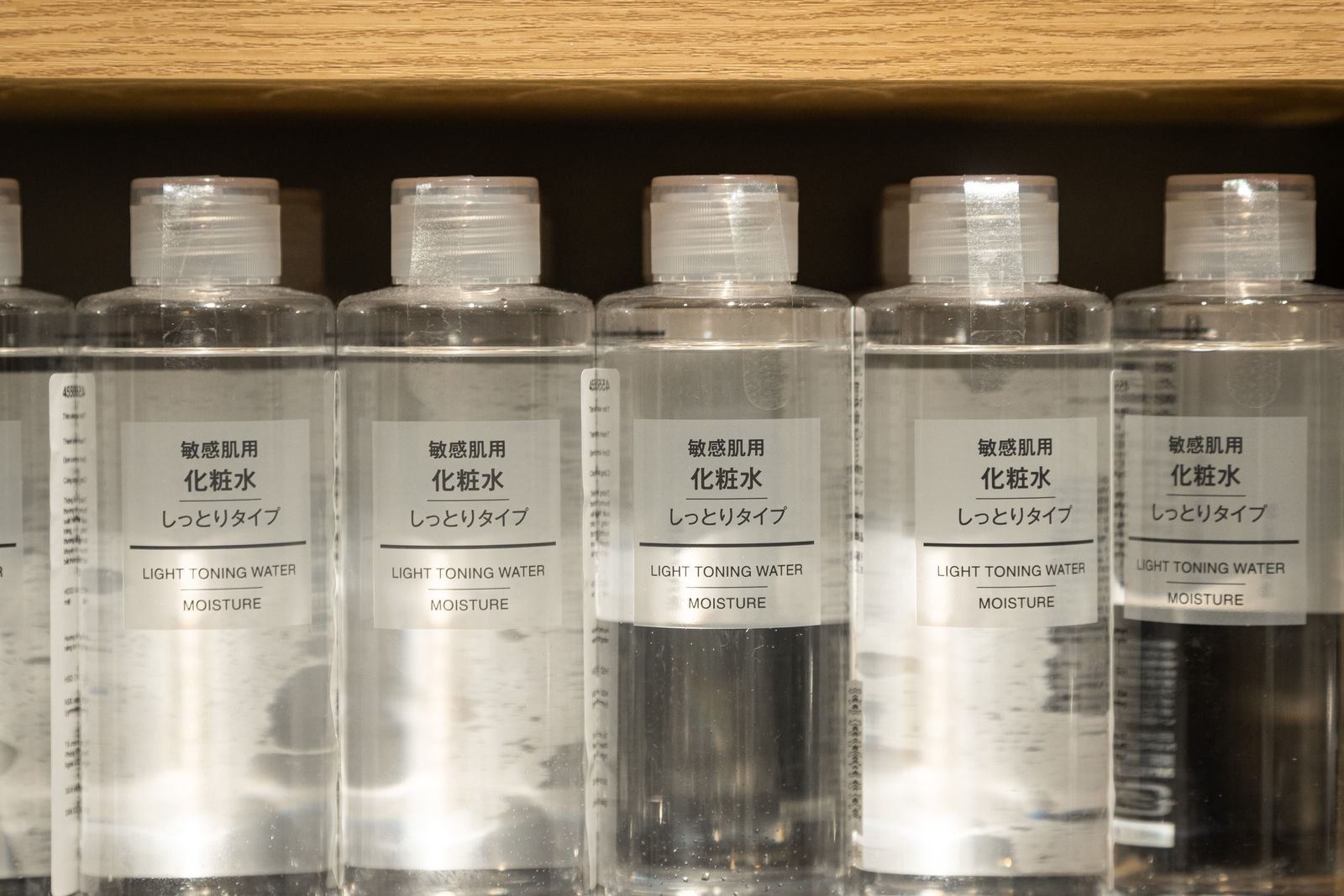 A row of Japanese-market toner bottles labeled for sensitive skin, moisture type, in plain packaging.