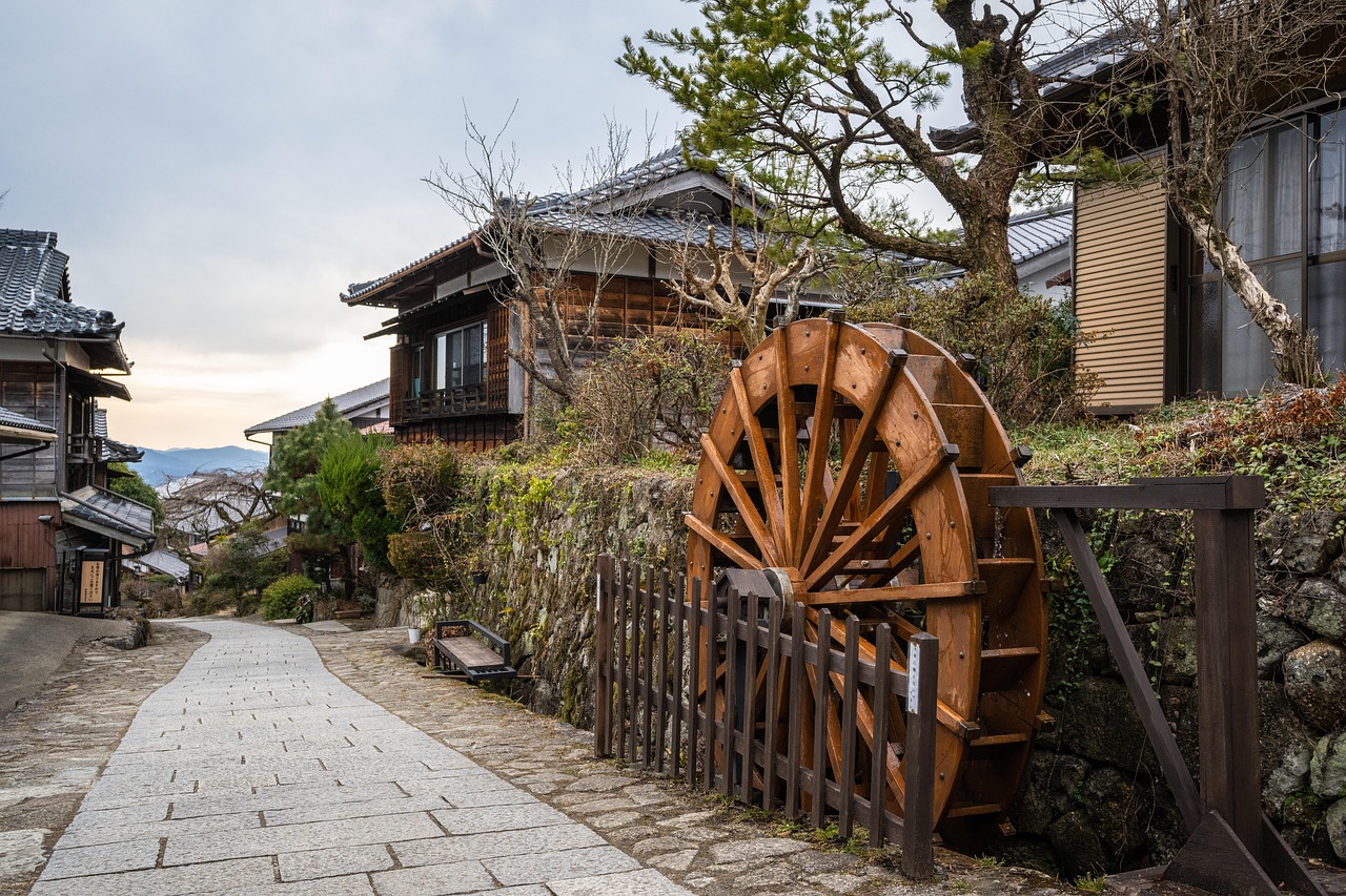 A wooden waterwheel beside the stone-paved path through Magome on the Nakasendo