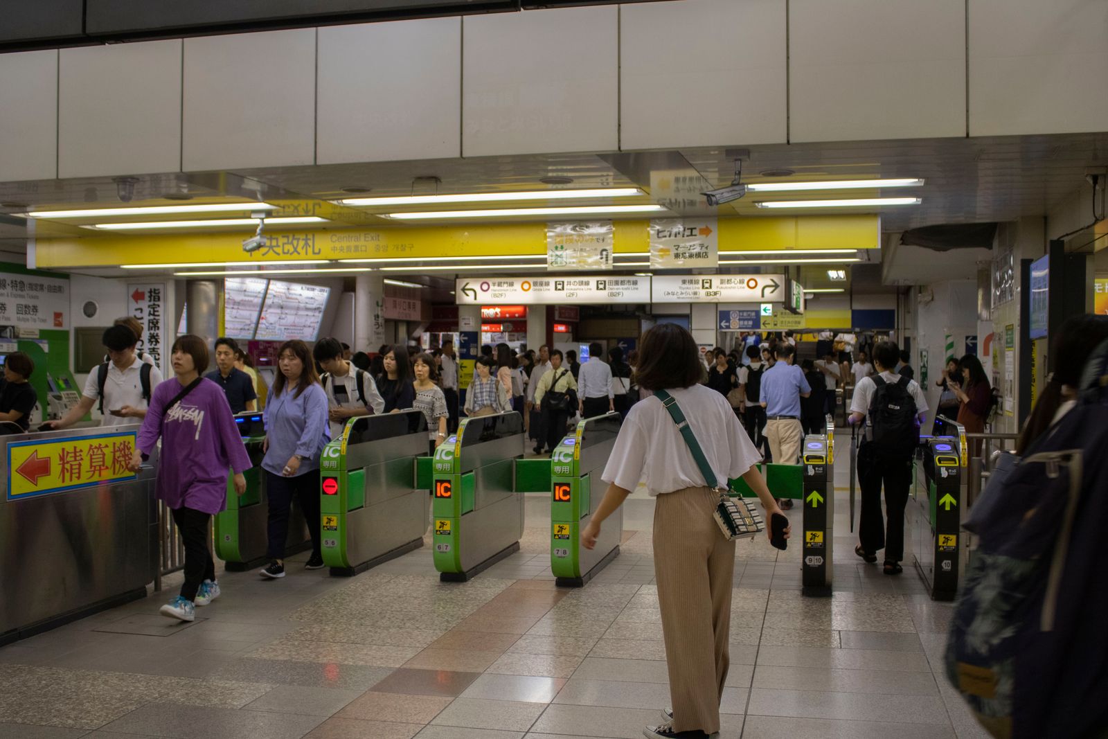 Commuters passing through subway ticket gates.