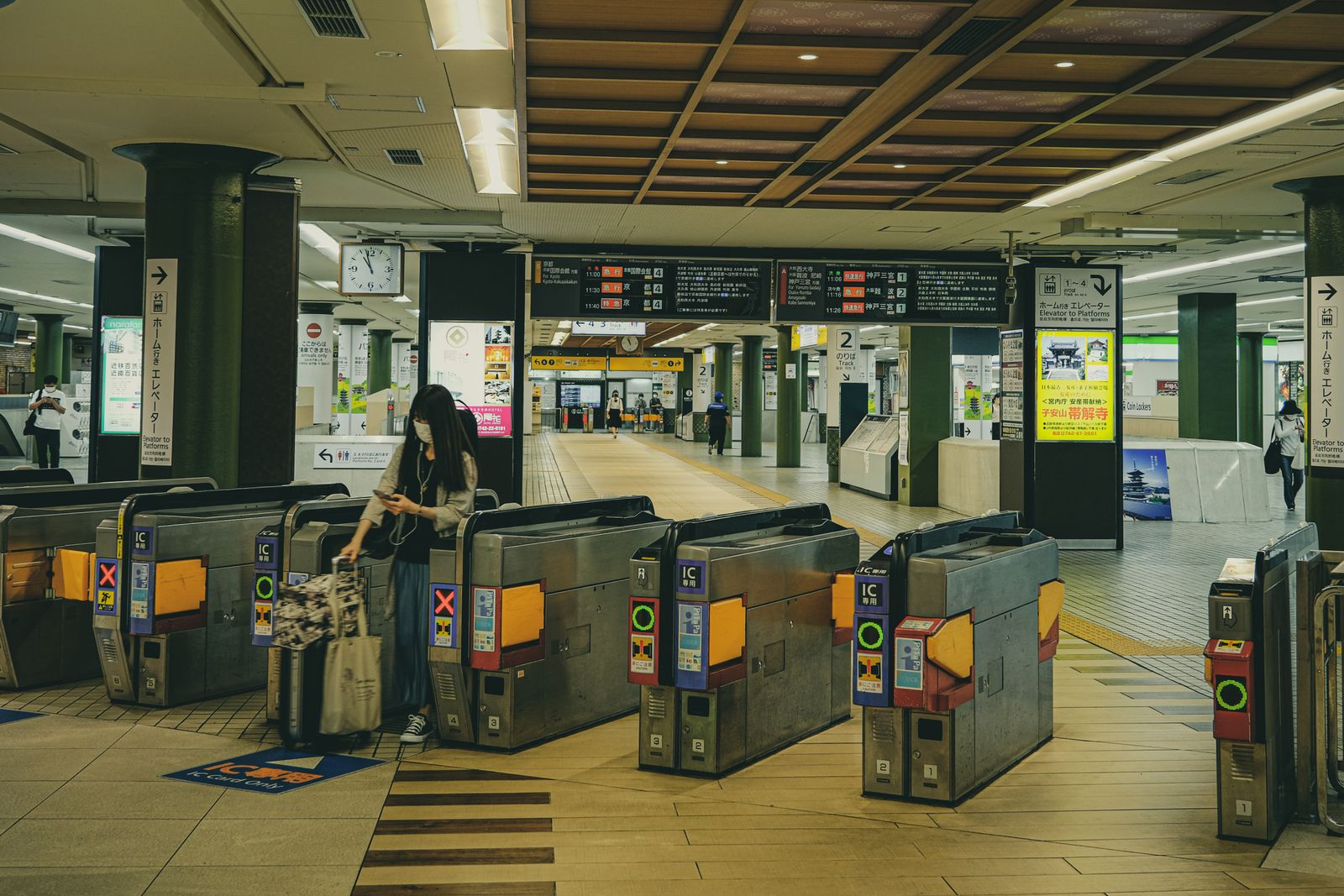 Japanese station ticket gates marked IC 専用, with an IC Card Only floor marking in front of them.
