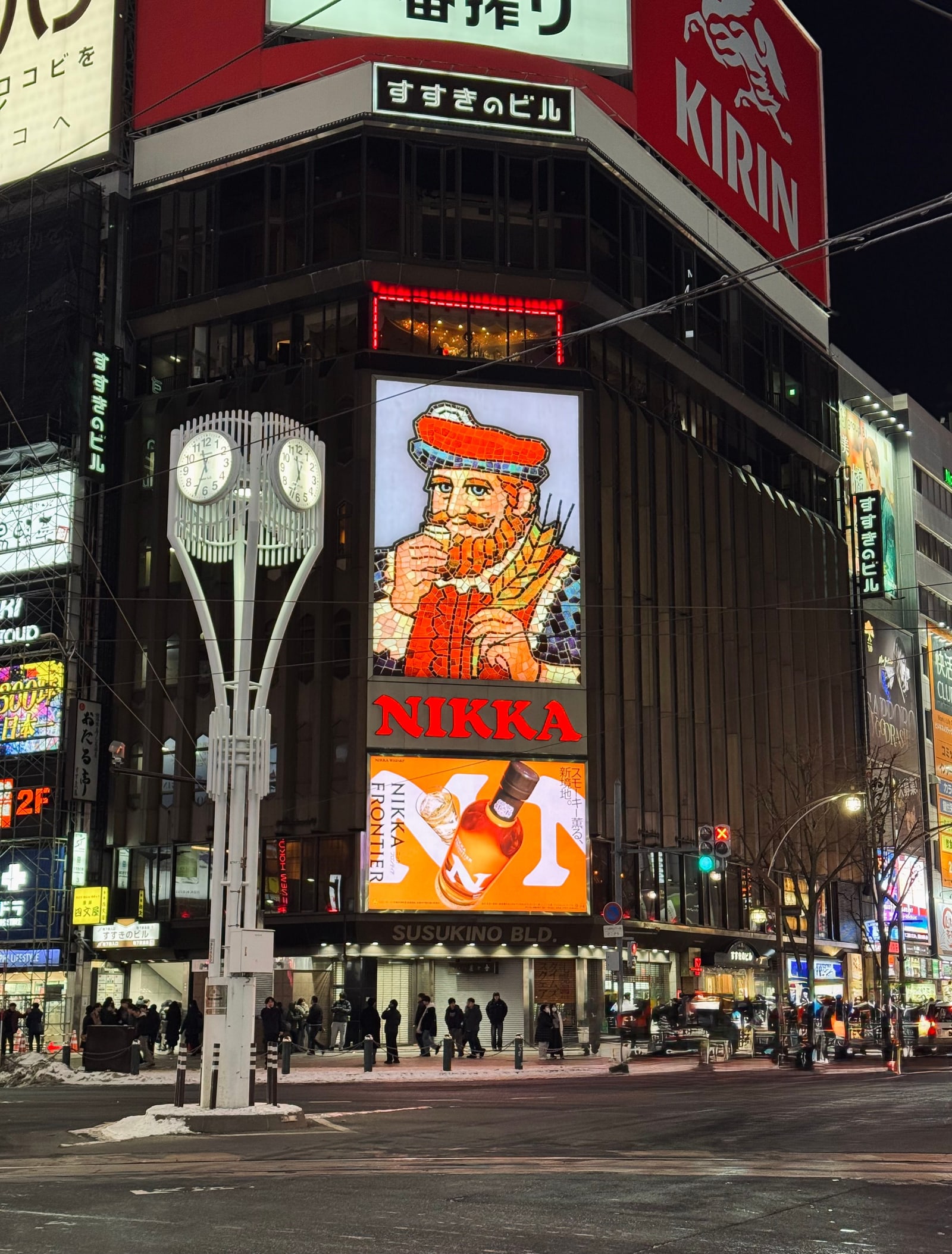 The Nikka Whisky sign lit on the Susukino Building at the Susukino crossing, Sapporo, at night.