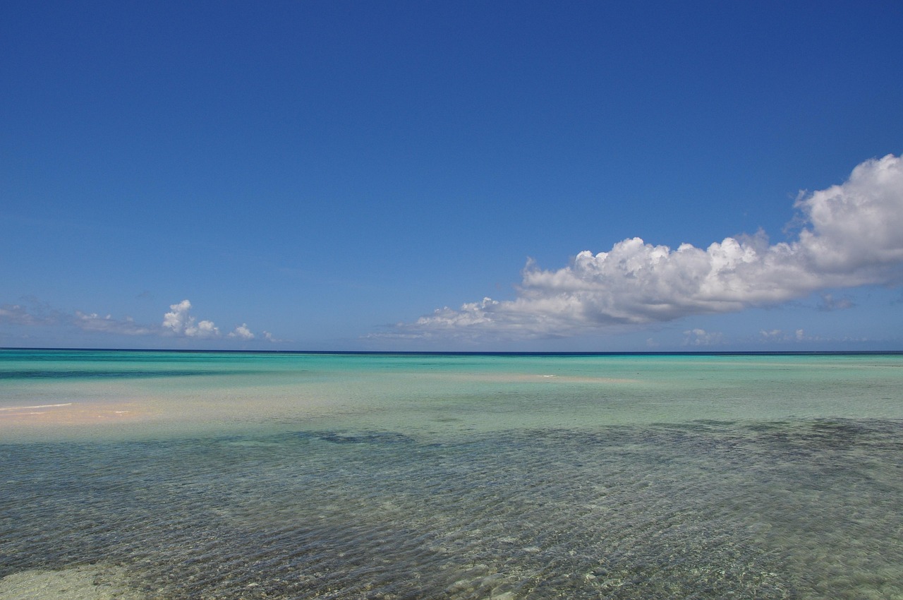 A bridge over clear shallow water seen from a sand beach in the Miyako Islands