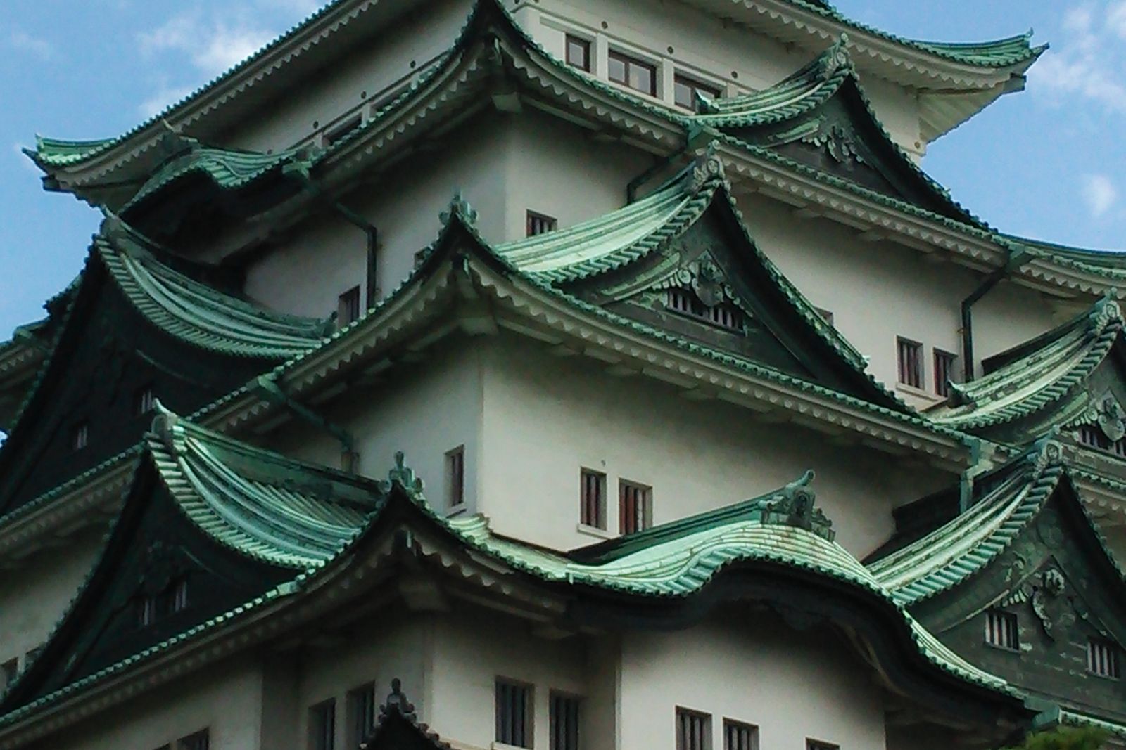 Nagoya Castle against a pale sky.