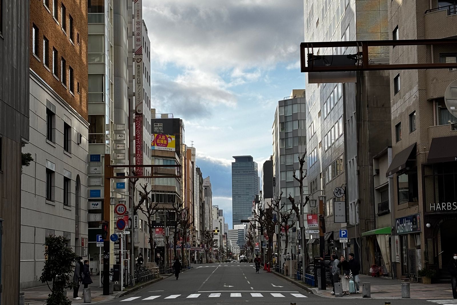 A Nagoya street with modern buildings under an overcast sky.