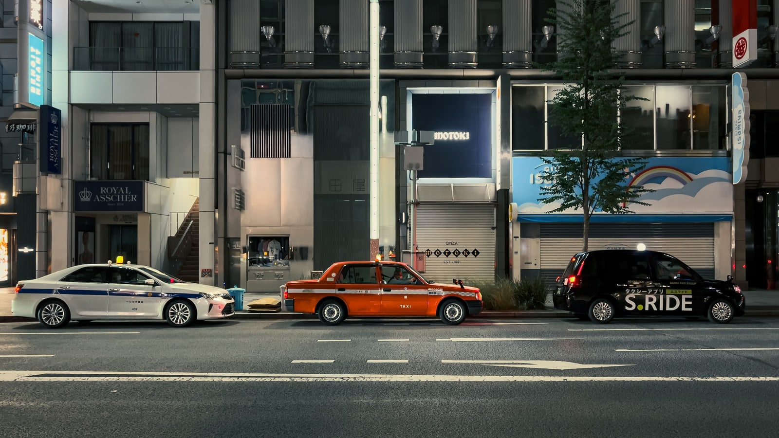 Taxis on a Tokyo street at night.