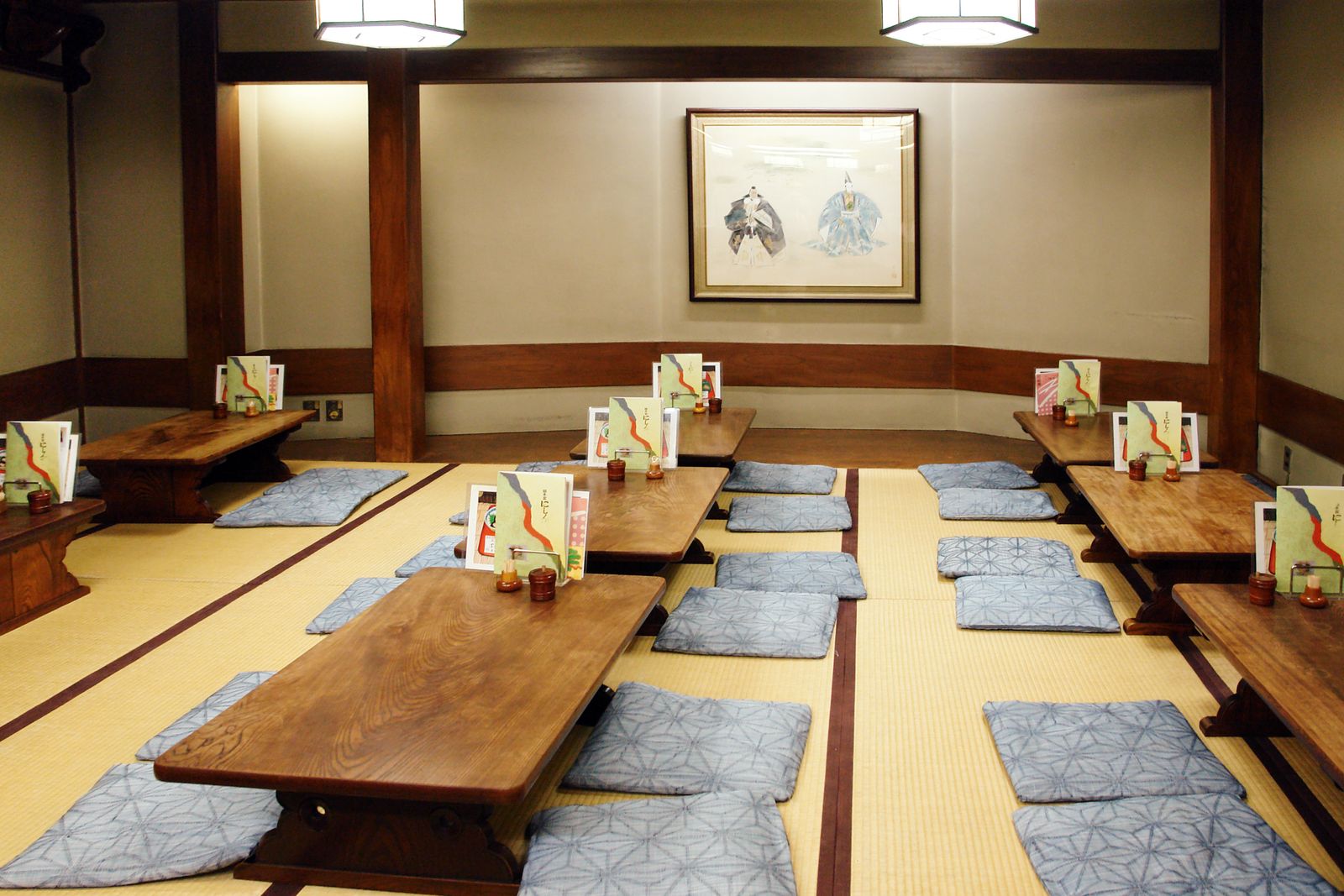 A tatami guest room laid out in ryokan style, with low table and floor seating.