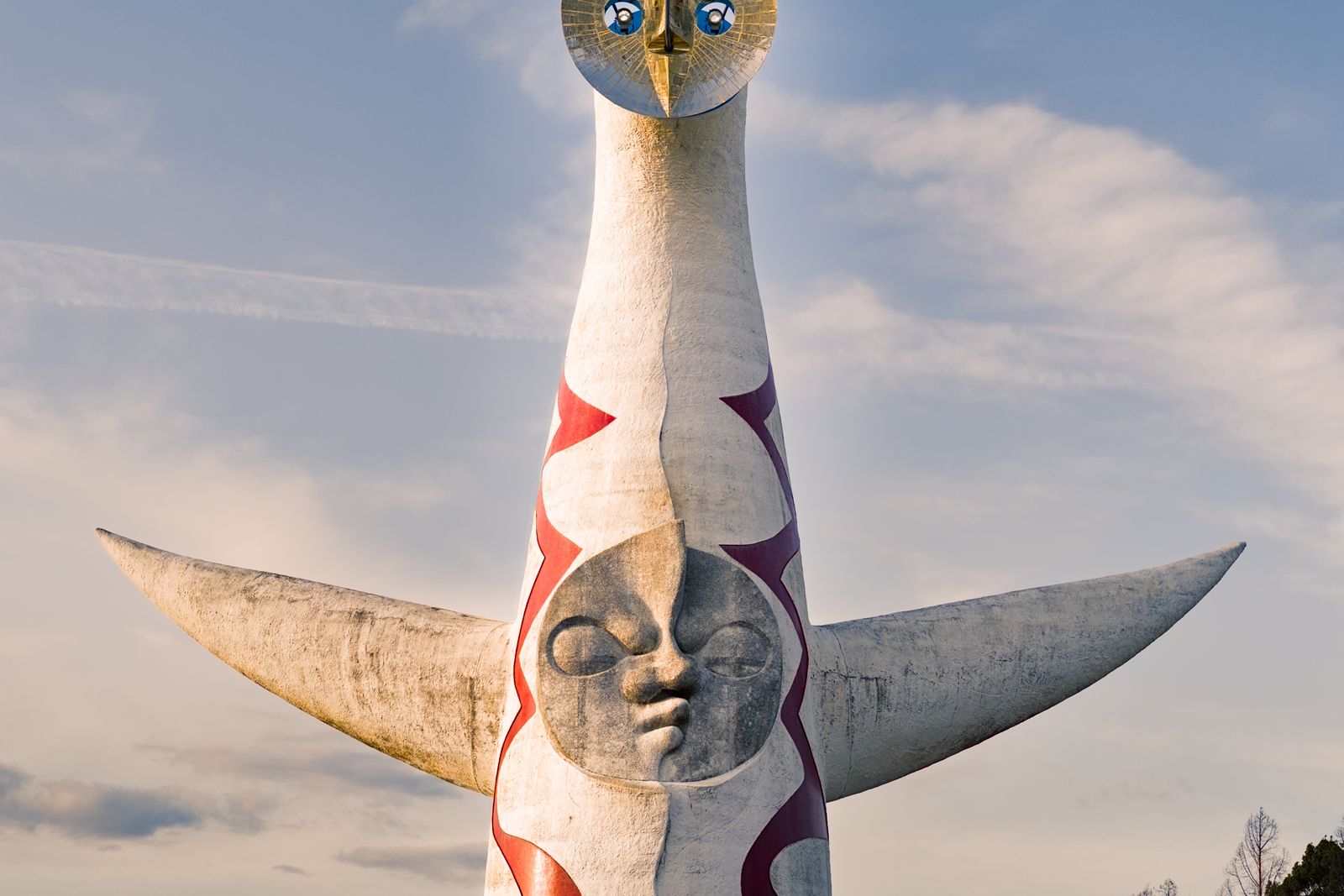 The Tower of the Sun in Expo '70 Commemorative Park against a pale blue sky