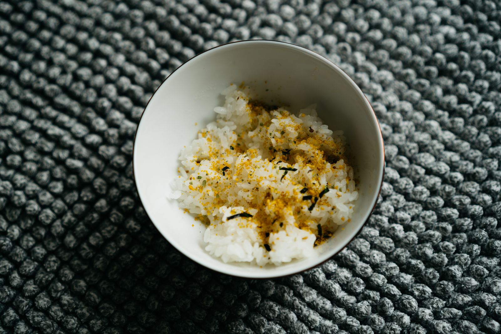 A bowl of rice topped with furikake seasoning.