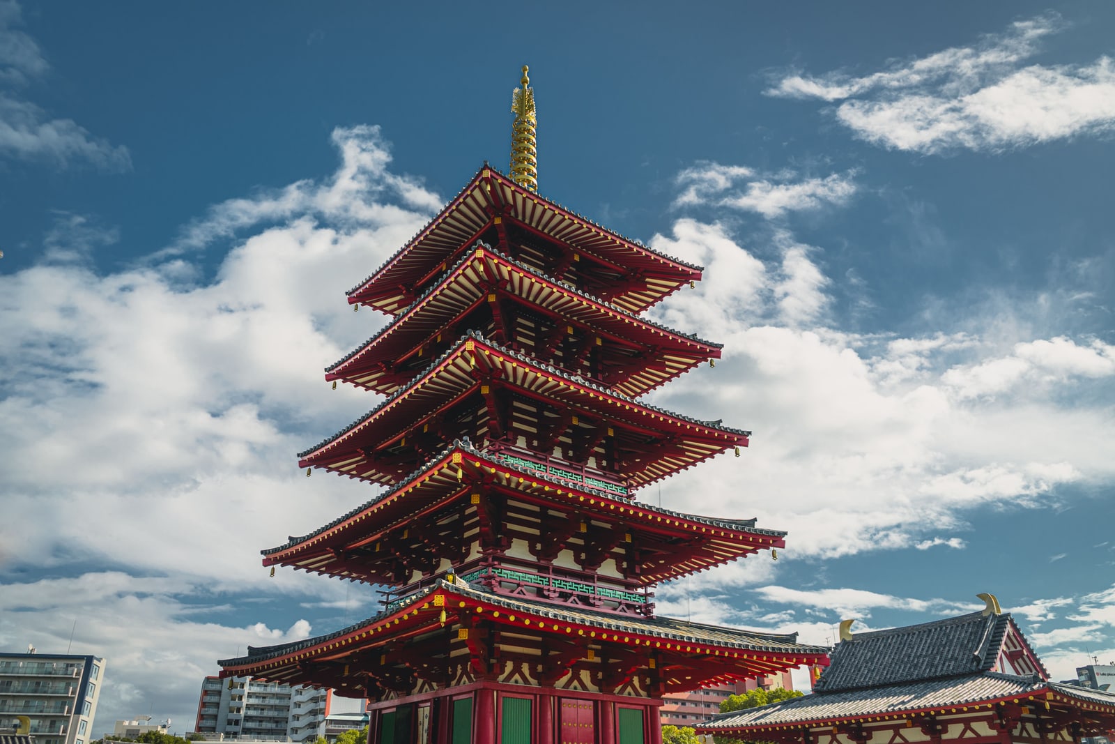 The five-storey pagoda of Shitennoji Temple against a blue sky with white clouds