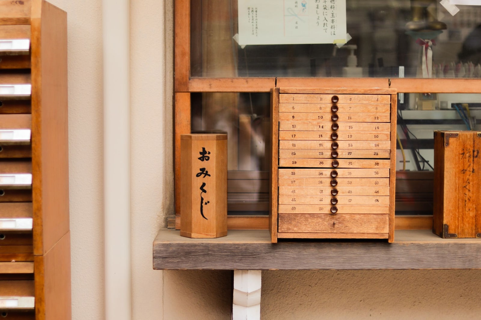 A wooden omikuji fortune-drawer cabinet at a shrine.