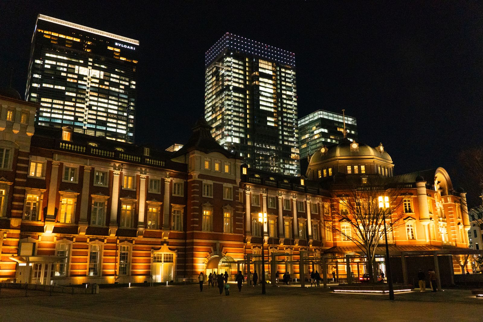 The brick facade of Tokyo Station lit up at night.