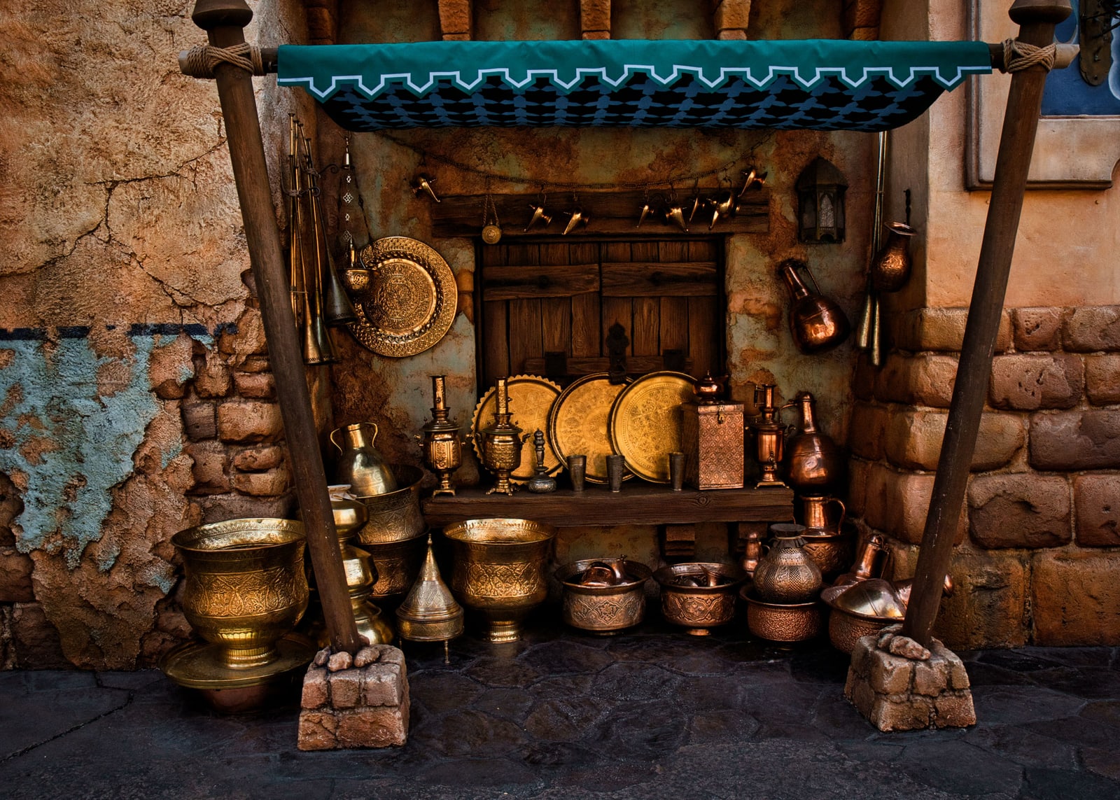 A market stall display of brass and copper vessels in the Arabian Coast area of Tokyo DisneySea