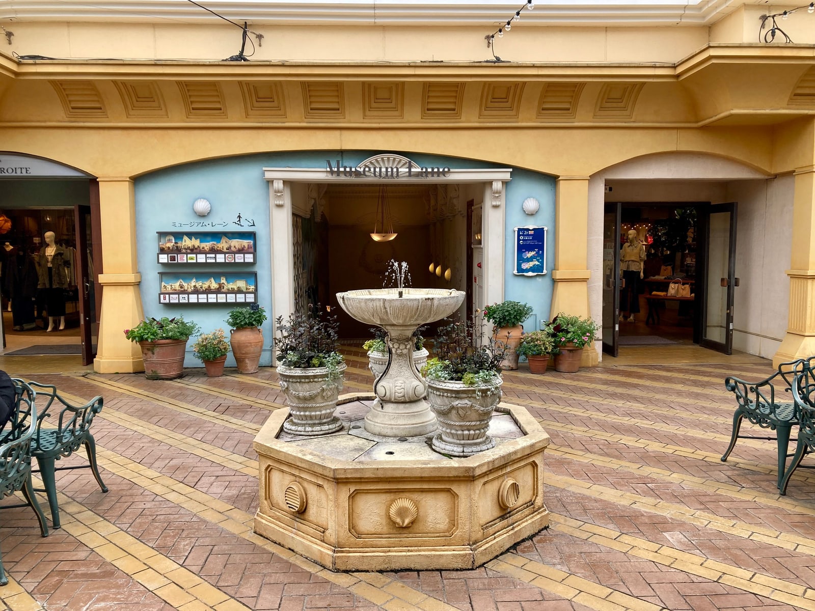 A courtyard fountain outside the Museum Lane storefront in Tokyo DisneySea's Mediterranean Harbor, quiet and near-empty.