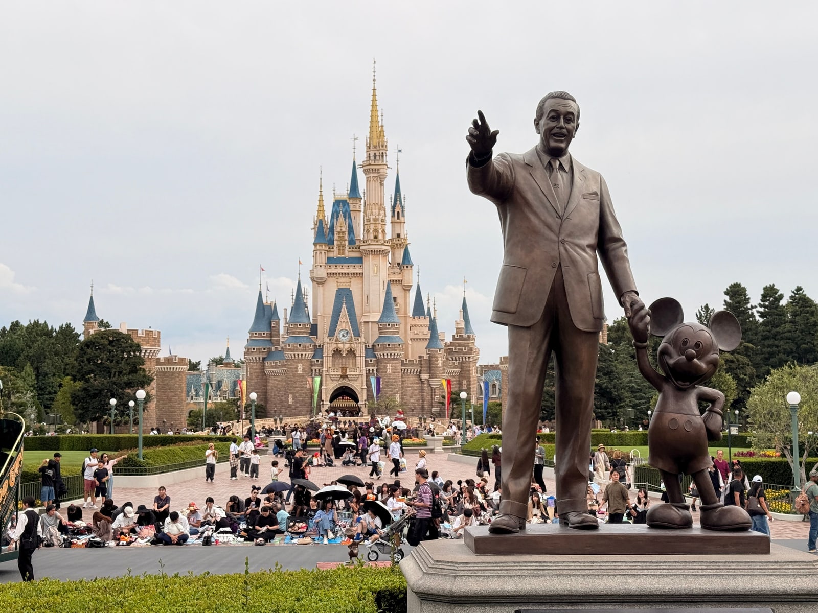 The Partners statue of Walt Disney and Mickey Mouse in front of Cinderella Castle at Tokyo Disneyland.