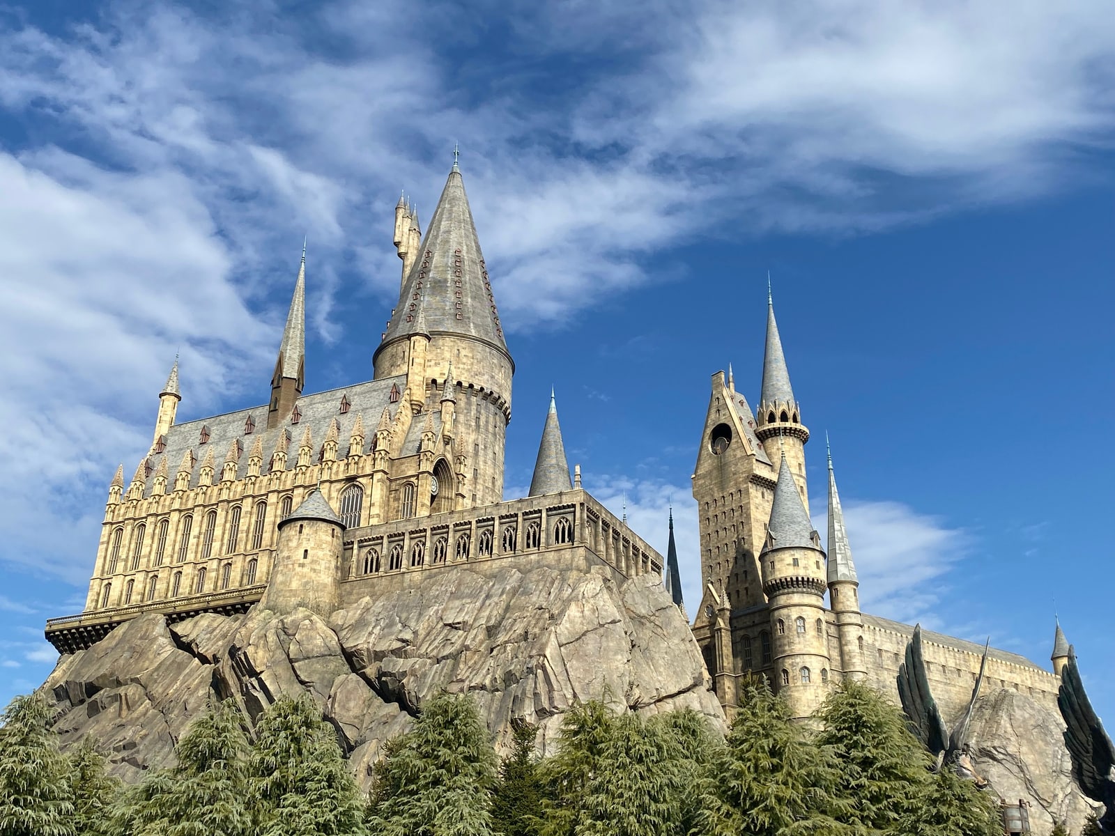 Hogwarts Castle rises against a clear blue sky at the Wizarding World of Harry Potter.