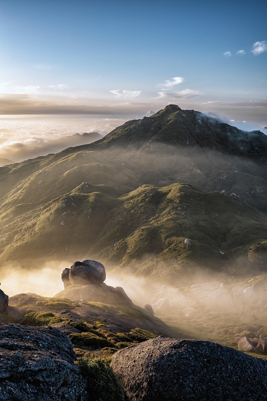 Grassy mountain ridges topped with granite boulders above a sea of cloud on Yakushima