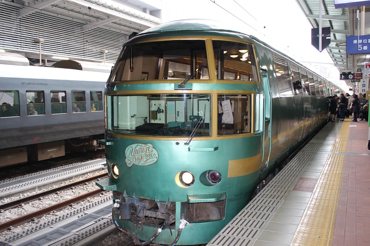 The green Yufuin no Mori limited express at a station platform